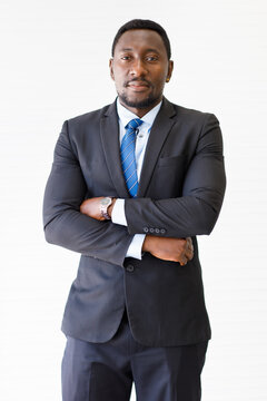 Portrait shot of smart and confident middle-aged African businessman in a neat formal black suit looking at the camera isolated with white background. Concept of successful CEO