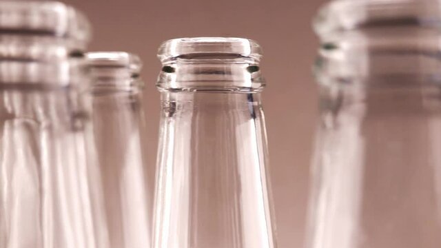 Tops Of Empty Transparent Glass Bottles Dolly Shot Closeup
