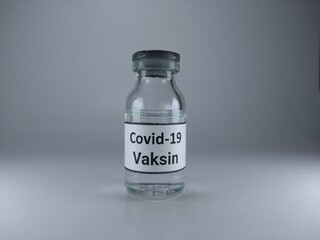 The word Covid 19 vaccine written in Indonesian language on a vaccine bottle 