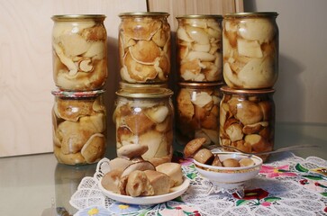 pickled white mushrooms salted in a jar and on a plate