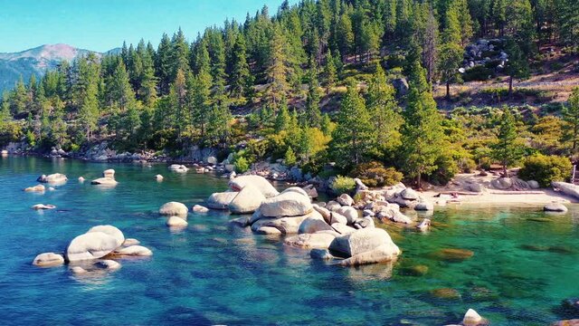 You will not see a better aerial view of the coastline of Lake Tahoe as a drone circles the shallow rocks in the crystal clear water and evergreen trees on the coast. You will want to climb the rocks.