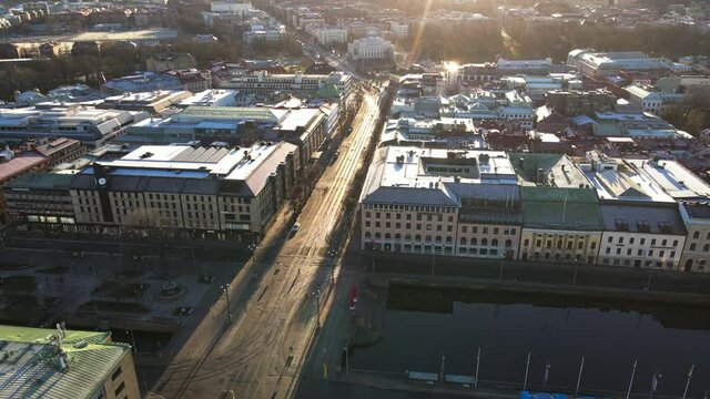 Early Morning View With Bright Sun Rays Above The Buildings And Old Street In Brunnsparken, Hamngatan In Gothenburg, Sweden - Aerial Drone Shot