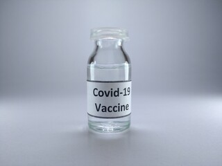 The word covid 19 vaccine written on a bottle of vaccine 