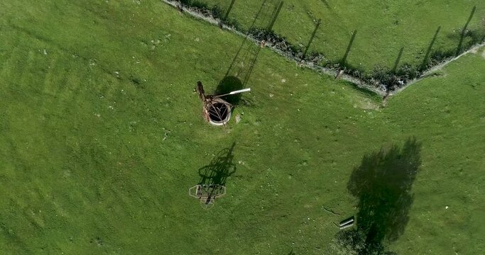 Aerial video Old wind power pump in Spanish farm surrounded by holm oaks