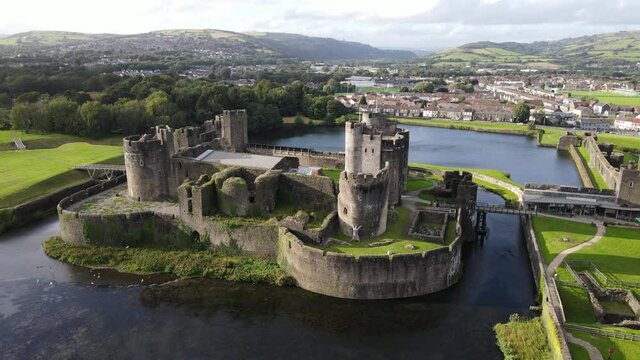 Birds fly by picturesque Caerphilly Castle in Wales aerial view