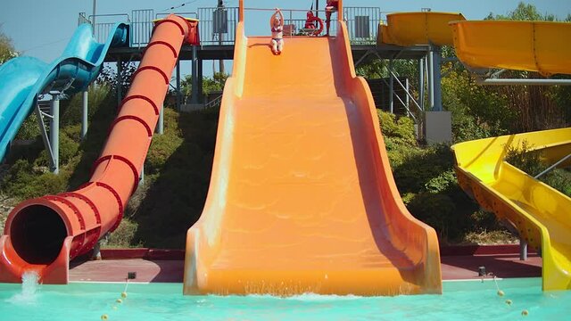 Young woman having fun on water slides