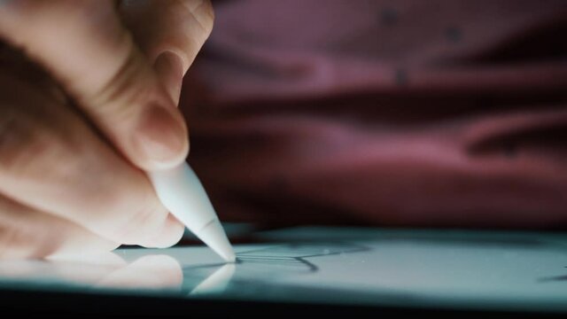closeup female hand draws on a graphics tablet