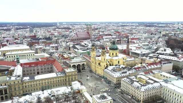 AERIAL Streets, Buildings and Cathedrals covered with snow in Germany, Munich