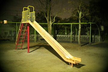 Tokyo,Japan-February 13, 2021: Vacant playground slide in a park at night in Tokyo
