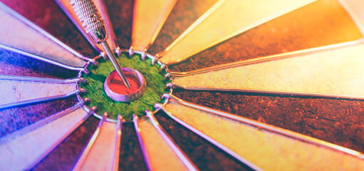 Dartboard showing a dart hit the center bullseye. Concept of success, targeted goal setting and...