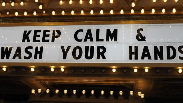 Keep Calm and Wash Your Hands Sign at Entrance of Closed Theatre During Covid-19 Virus Lockdown in USA, Close Up