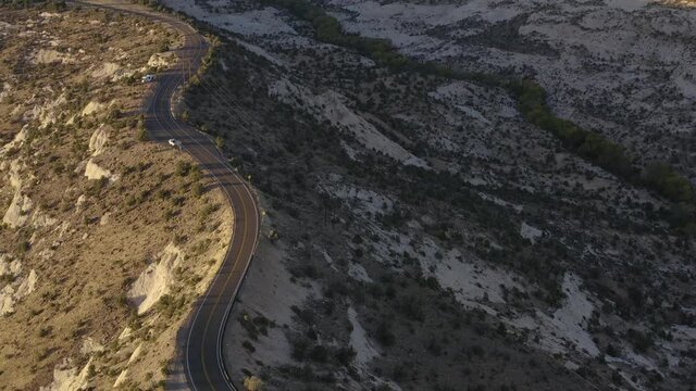 High Aerial View of Winding Road Passing Through Desolate Desert Landscape in Southern Utah
