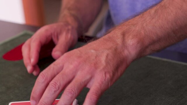 Man playing French cards at home