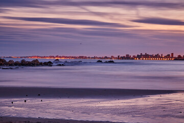 landscape on the beach of warm colors at sunset with a city behind © ares