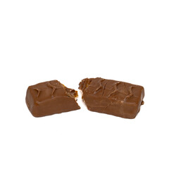 Tasty chocolate bar split in two pieces isolated on white background. Delicious caramel cream and peanuts inside