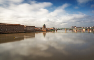 Reflection of Toulouse city over garonne river at day