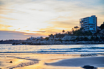 landscape on the beach of warm colors at sunset with a city behind © ares