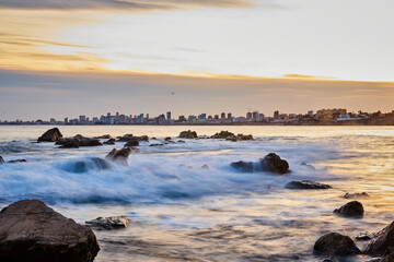 landscape on the beach of warm colors at sunset with a city behind © ares