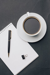 notebook on the table coffee cup pen office work business