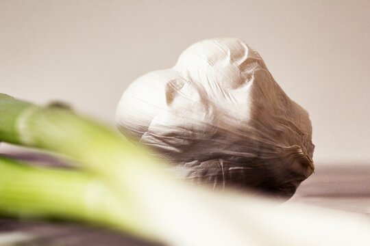 Close-up of garlic and scallion on table