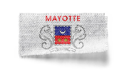 Mayotte flag on a piece of cloth on a white background