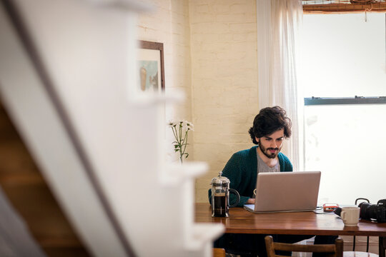 Man using laptop computer while sitting at home