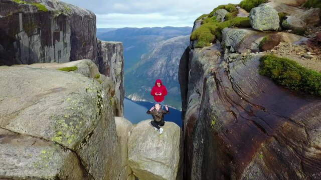 Couple standing on pulpit rock in Norway