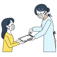 看護師から説明を受ける女性（マスク）