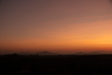 Morning blur over mountains and trees. The first and last light of the day in sky with beautiful
