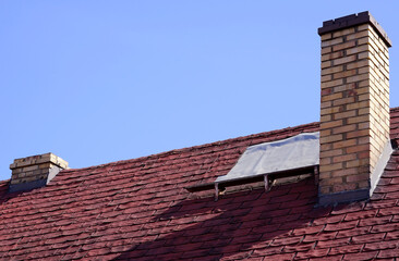 old, patched roof covered with roofing felt 