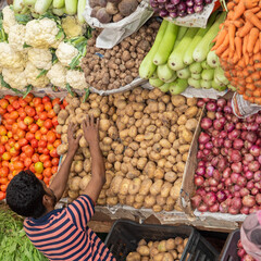 Top view of Indian fruit and vegetable vendors selling their product to locals in a local markets setup in India, Goa