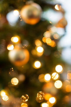 Defocused image of ornaments on illuminated Christmas tree