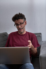 Man holding a video conference from home