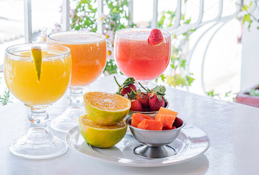 Natural fruit juices on a restaurant table.