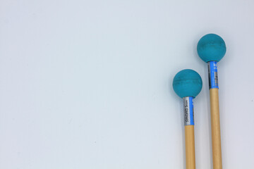 Detail of xylophone mallets in the right side on a white background.