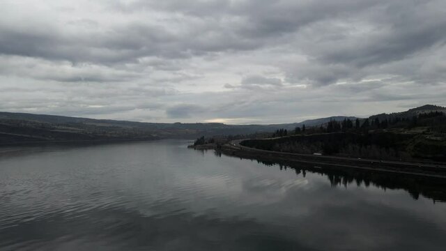 Dark storm clouds reflect off the rippled Columbia River waters, aerial