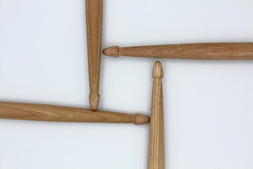 Drumsticks placed geometrically on a white background