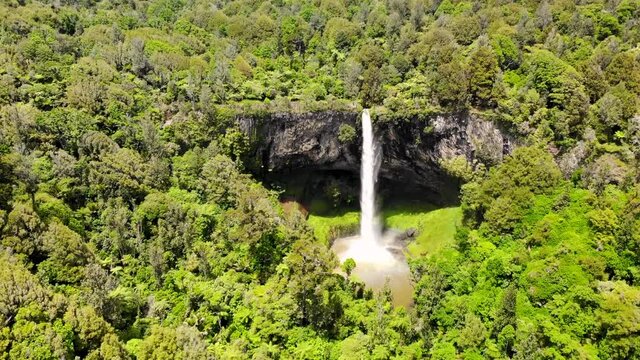 Aerial shot of spectacular Bridal Veil Falls, lagoon and rainbow. New Zealand