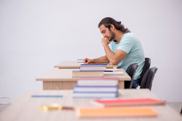 Young male student in the classroom during pandemic