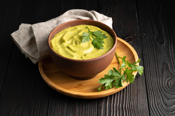 squash caviar with parsley in a bowl on a wooden background