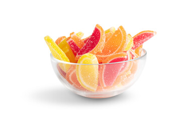 sugar jelly candies in a glass bowl in the form of fruit slices isolated on a white background