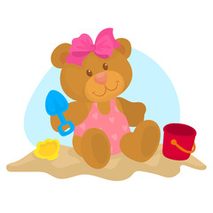 Obraz na płótnie Canvas baby bear playing in the sand with her beach toys 