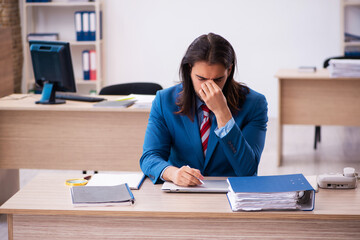 Young male employee working at workplace