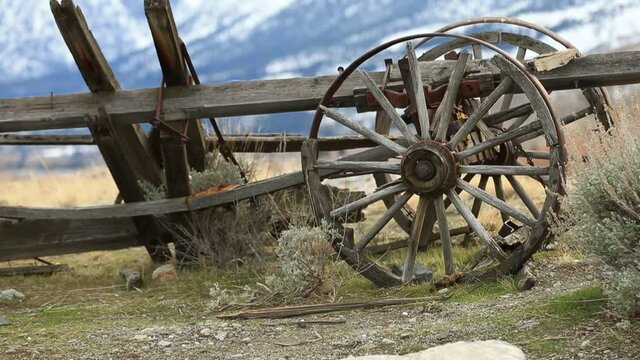 Old Wooden Wagon with Wheel and Snowy Mountain Background - Shallow DOF