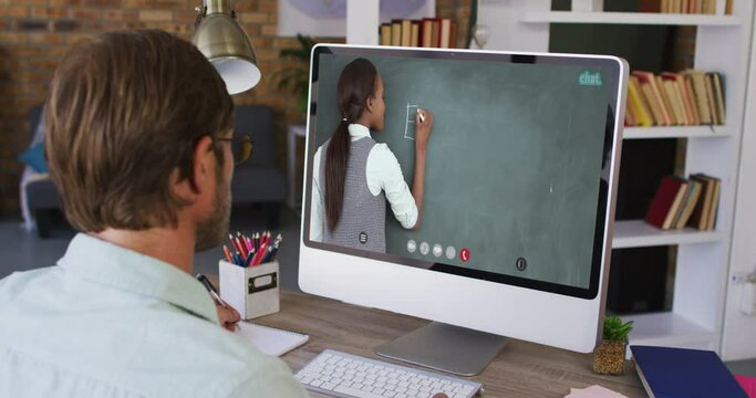 Caucasian male student using computer on video call with female teacher