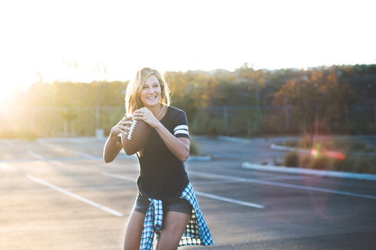 Cheerful Woman Playing With American Football Parking Lot