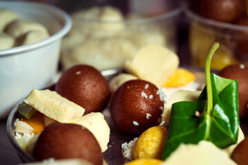 Indian Sweets Thali For Puja. Background for Traditional sweets thali, prasad or bhog prepared for Saraswati pooja, Lakshmi, Durga puja, vasant panchami. Concept for Hindu religious cultural tradition