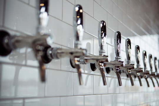Row of beer taps at brewery