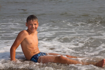 Fototapeta premium European boy, teenager, swimming in the sea.