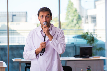 Young male doctor working in the clinic
